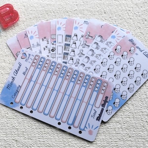 May include: A selection of planner stickers in shades of pink, blue, and white. The stickers display various designs, including icons, text, and budget trackers. The text on the stickers includes "Month Ahead!", "Gas and Electric", and "Brianna Budgets".