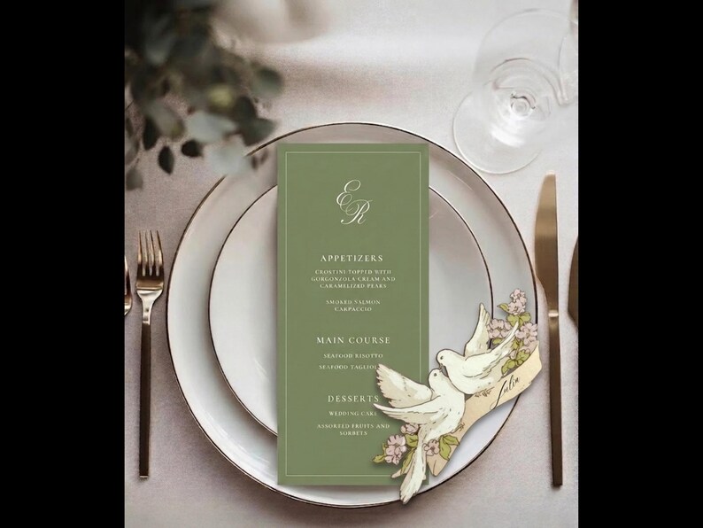 May include: A formal table setting with a green menu card, white plates, and gold silverware. The menu card features the initials "ER" and a list of courses. A decorative dove and floral accent adds a touch of elegance.