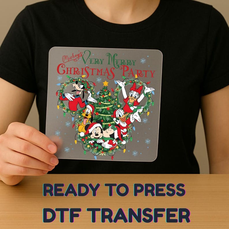 May include: A gray DTF transfer featuring Mickey Mouse and friends celebrating Christmas. The design includes Mickey, Minnie, Donald, Daisy, Goofy, and Pluto around a Christmas tree. The text "Mickey's Very Merry Christmas Party" is at the top.