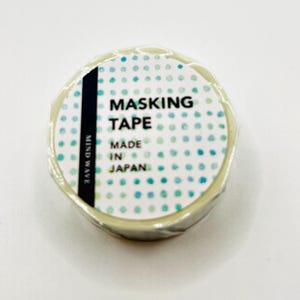May include: A roll of masking tape with a white label featuring the text "MASKING TAPE MADE IN JAPAN" and a pattern of blue and teal dots. The brand name "MIND WAVE" is printed on the side.