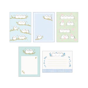 May include: A collection of stationery cards featuring illustrations of pairs of white birds perched on branches. The cards have various pastel backgrounds, including blue and green, with floral and gingham patterns. Some cards have blank spaces for writing.