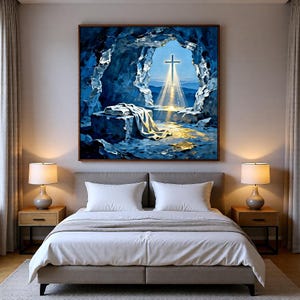 May include: A framed painting depicts a cross illuminated by a beam of light emerging from a cave. The artwork features a blue and white color palette, with a draped cloth in the foreground. The painting is displayed above a bed with white linens.