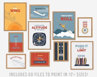 May include: A collection of framed aviation-themed art prints. Each print features a unique design with aviation-related text and graphics, including airplanes, instruments, and motivational phrases. The prints are in various colors, including orange, blue, and red.