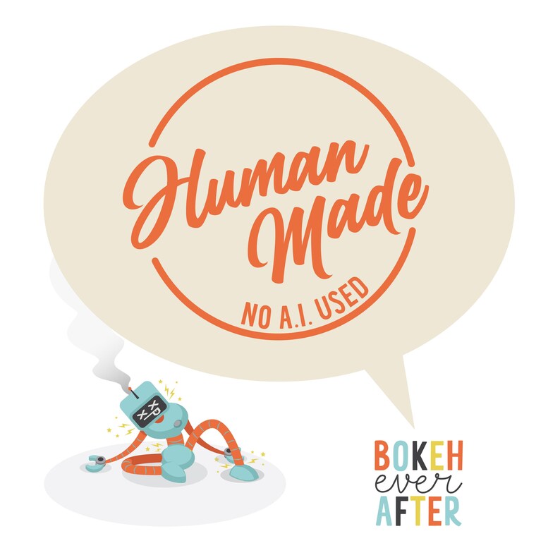 May include: A graphic illustration featuring a light blue robot with orange limbs and X-shaped eyes emitting smoke from its head. Above the robot is a large beige speech bubble containing the orange text Human Made NO A.I. USED. Below is BOKEH ever AFTER.