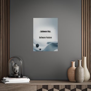 May include: A framed print with the words "Software Bug" and "Software Feature" in black text. The artwork features a blue and white abstract design with a sphere and insect-like shapes. The print is displayed on a grey wall.