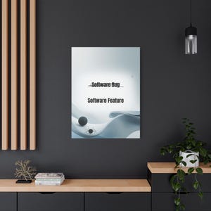 May include: A canvas print with the words "Software Bug" and "Software Feature" in black. The artwork has a light blue and white abstract design with a dark sphere and insect-like shapes.