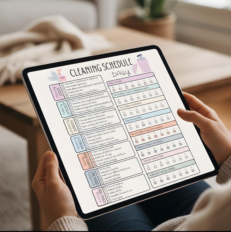 May include: A digital cleaning schedule on a tablet. The schedule is divided into daily, weekly, and monthly tasks, with checkboxes for each task. The text "CLEANING SCHEDULE DAILY" is at the top. The schedule includes tasks for the kitchen, living room, bedrooms, and bathrooms.