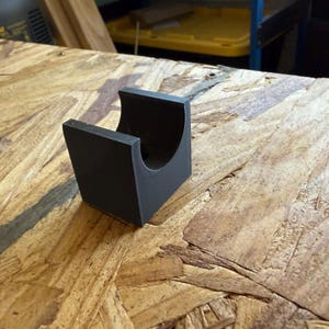 May include: A set of three ceramic mugs with a speckled, cream-colored glaze. Each mug features a different hand-painted floral design in shades of blue, green, and yellow. The mugs have a simple, modern shape.