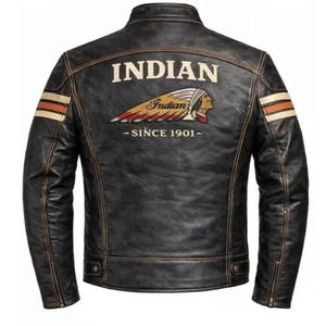 May include: Black leather jacket with the word "INDIAN" across the back. The jacket features a logo with a Native American profile and the text "Indian Since 1901." The jacket has brown and white stripes on the sleeves.
