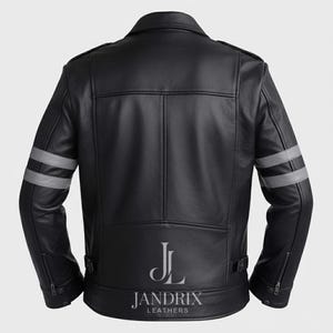 May include: Black leather jacket with silver stripes on the sleeves. The jacket has a classic biker style with a notched collar, zipper pockets, and a belt at the waist. The brand name "Jandrix Leathers" is printed at the bottom.