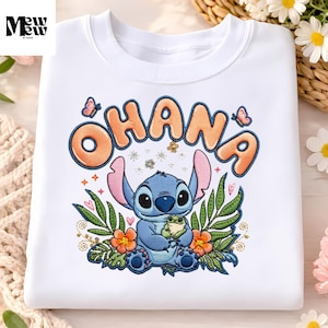 A white t-shirt with a colorful embroidered design featuring a character from the Disney animated film "Stitch" surrounded by flowers and butterflies.