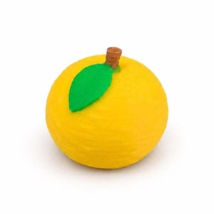 May include: A round, yellow citrus fruit figurine with a textured surface. It features a single, bright green leaf attached to the top, centred next to a small, brown, cylindrical stem. The object has a spherical shape and a matte finish.