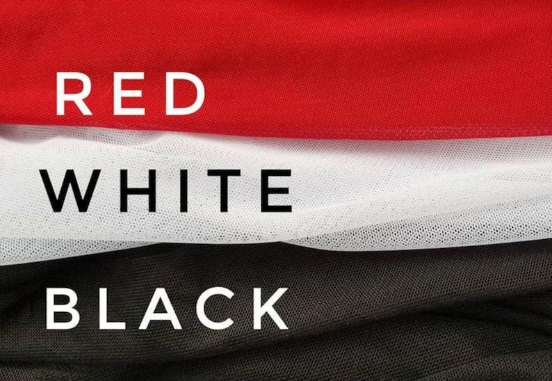 May include: Close-up of three fabric swatches in red, white, and black. The word "RED" is printed in white block letters above the red fabric. The word "WHITE" is printed above the white fabric, and "BLACK" above the black fabric.