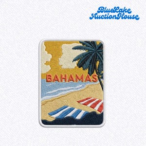 May include: A rectangular embroidered patch featuring a beach scene with a palm tree, yellow sky, and blue ocean. The word BAHAMAS is stitched in orange letters across the center. Two striped beach towels in blue-white and red-white lie on the sand.