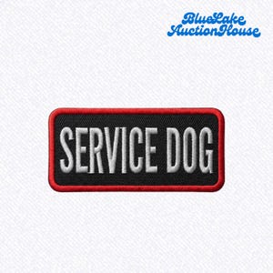 May include: A rectangular embroidered patch with a black background and a red border. The text SERVICE DOG is stitched in white capital letters across the center. The BlueLake AuctionHouse logo is visible in the upper right corner of the image.
