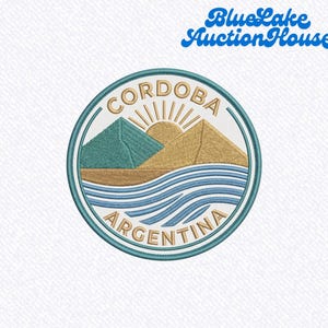 May include: Embroidered patch featuring a circular design with the text "CORDOBA ARGENTINA". The design includes mountains, a sun, and water in shades of teal, gold, and blue, with a teal border. The text "Blue Lake Auction House" is above the patch.