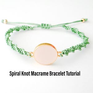 May include: A green macrame bracelet with a spiral knot design and a round, light pink charm. The charm is set in a gold-toned metal frame. "Spiral Knot Macrame Bracelet Tutorial" is written below the bracelet.