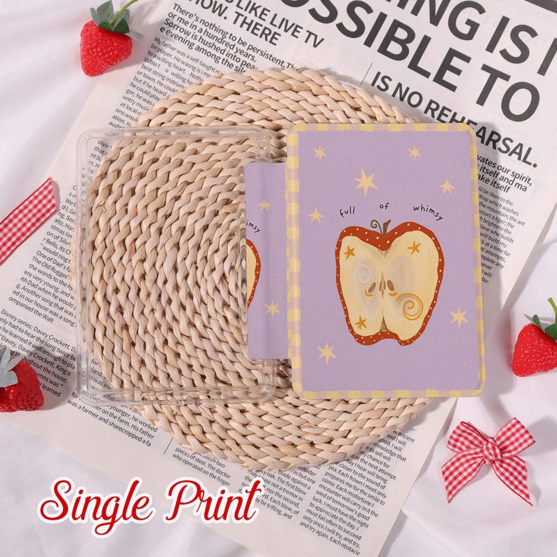 May include: A clear phone case with a purple card featuring an apple illustration and the words "full of whimsy." The card is surrounded by yellow stars. The words "Single Print" are at the bottom.