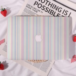 May include: A laptop hard shell case featuring a vertical pastel striped pattern in shades of light pink, blue, yellow, and green. The case has a centered cutout for an Apple logo. The design is clean, matte, and covers the entire top surface.