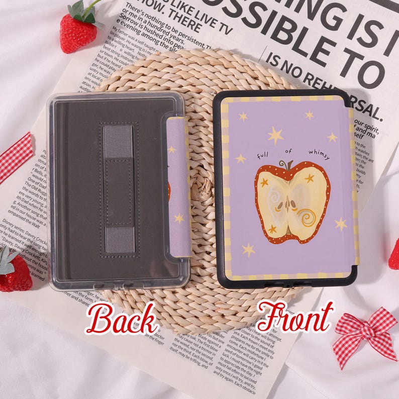 May include: A lilac e-reader case featuring an apple illustration and the words "full of whimsy." The case has a clear back and a stand. The front of the case has a black border. The back of the case is clear.