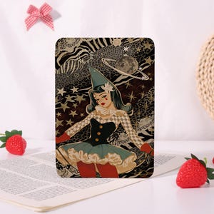 May include: A rectangular print featuring a stylised illustration of a figure in a jester costume with a pointed hat, ruffled collar, and checkered sleeves. The background displays a dark celestial pattern with stars, a planet, and animal print.