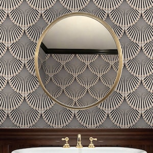 May include: A bathroom with a gold-framed mirror and a white bathtub. The wall features a black and white fan-shaped pattern. The faucet and fixtures are gold. The lower wall is dark wood.