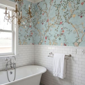 May include: A bathroom with a clawfoot tub, white subway tile, and a floral wallpaper in shades of blue, green, and red. A brass chandelier hangs above the tub, and a white towel hangs on a chrome towel rack.