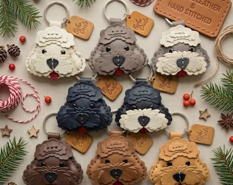 May include: A collection of seven leather dog-shaped keychains in various colors including white, gray, black, brown, and tan. Each keychain features a metal ring, a small square tag labeled Boho Circle, and a red tongue. A leather tag reads Genuine Leather & Hand Stitched.