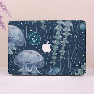 May include: A laptop case featuring a blue and white jellyfish design. The case has a dark blue background with illustrations of jellyfish, sea plants, and small dots. A white Apple logo is visible.