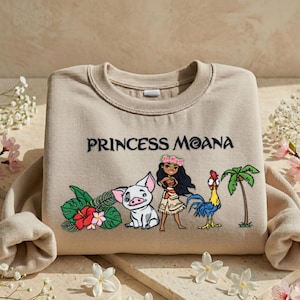 A beige t-shirt with a design featuring characters from the Disney movie " princess Moana".