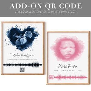 May include: Two framed prints with baby-themed art. One features a blue watercolor image of a fetus in a heart shape, the other a pink watercolor image of a baby's face. Both include the name "Baby Penelope", a heartbeat graphic, and a QR code. The text "ADD-ON QR CODE" is at the top.