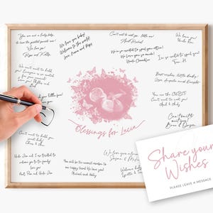 Puede incluir: Un libro de visitas de baby shower enmarcado con un diseño rosa y blanco. La obra de arte presenta una ilustración de un bebé rodeado de mariposas y las palabras "Blessings for Lucia". Una mano dibuja un corazón en el tablero con un bolígrafo. También se incluye una tarjeta que dice "Share your Wishes".