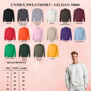 May include: A display of Gildan 18000 unisex sweatshirts in various colors, including black, dark gray, and red. The image also shows a size chart with measurements in inches for width and length, ranging from size S to 2XL.
