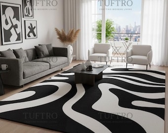 May include: A black and white patterned area rug with a wavy design dominates the foreground of a living room. A gray sofa, two white armchairs, and a dark coffee table are also visible. The room has large windows and artwork on the wall.