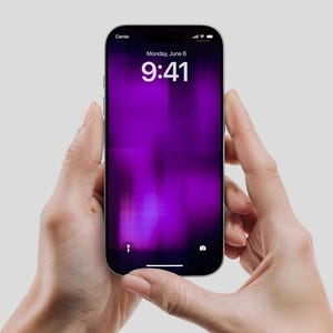 May include: A black smartphone with a purple screen displaying the time as 9:41 AM on Monday, June 6. The phone is held between two hands against a light gray background. The word "Carrier" is visible at the top.