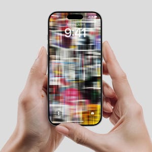 May include: A silver smartphone held in two hands, displaying a colorful, abstract wallpaper. The screen shows the date as Monday, June 6, and the time as 9:41. The phone has a black border and a camera cutout at the top.