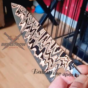 May include: A knife blade featuring a distinct wavy, multi-layered pattern in shades of black, silver, and copper. The blade displays the text Briastrow Sports with a crossed sword logo and the text Bairstrow sports printed on the metal surface.