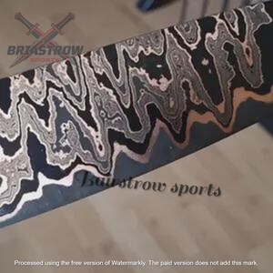 May include: A metal blade featuring a distinct wavy, layered pattern in shades of black, grey, and copper. The surface displays the text Briastrow Sports with a crossed sword logo and the text Bairstrow sports printed across the metal surface.