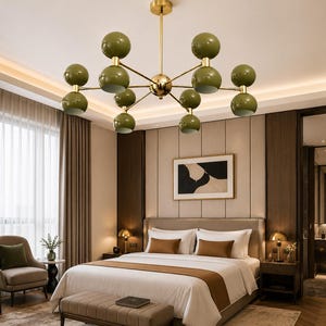 May include: A ceiling chandelier featuring a central gold-toned metal rod with multiple branching arms, each ending in a pair of stacked olive green spherical globes. The fixture is suspended from the ceiling, showcasing a symmetrical design.