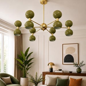 May include: A multi-arm chandelier featuring a polished gold-tone central rod and branching arms that support ten spherical olive green shades. Each arm holds two stacked spheres, creating a symmetrical, radial design suspended from the ceiling.