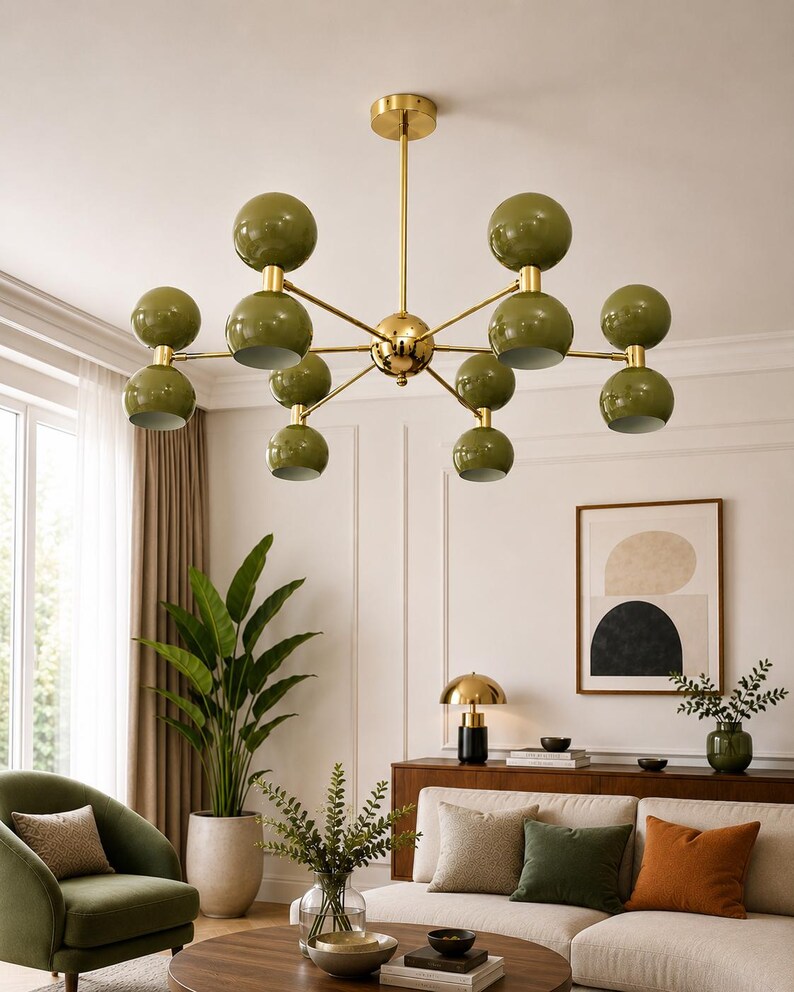 May include: A multi-arm chandelier featuring a polished gold-tone central rod and branching arms that support ten spherical olive green shades. Each arm holds two stacked spheres, creating a symmetrical, radial design suspended from the ceiling.