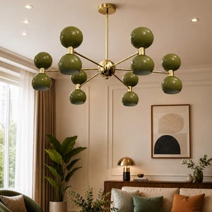 May include: A multi-arm chandelier featuring a central gold-toned metal rod and branching arms that support ten glossy olive green spherical light fixtures arranged in pairs, creating a symmetrical, radial design suspended from the ceiling.