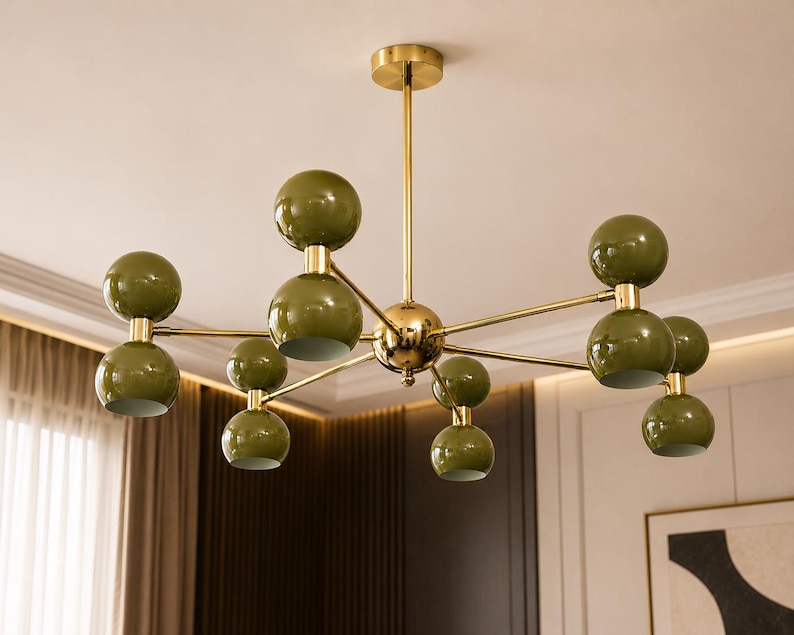 May include: A ceiling chandelier featuring a central gold-toned metal rod and frame with multiple branching arms. Each arm holds two spherical olive green shades, creating a symmetrical arrangement of ten globe-shaped light fixtures in total.
