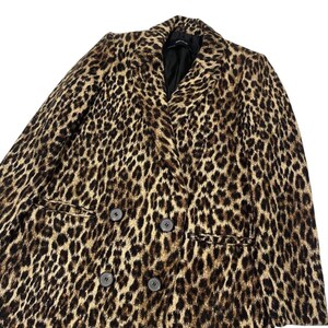 May include: A double-breasted leopard print blazer in shades of brown and black. The blazer features a notched collar, two front pockets, and four dark buttons. The garment is made of a soft, textured fabric.