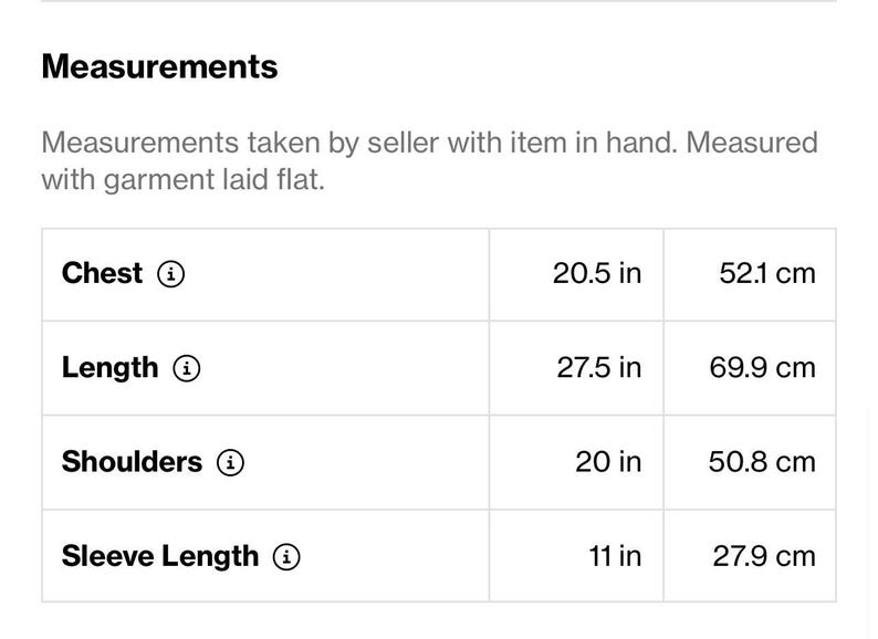 May include: Measurements of a garment, including chest (20.5 in), length (27.5 in), shoulders (20 in), and sleeve length (11 in). Measurements are taken with the garment laid flat.