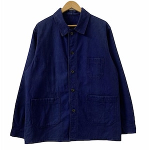 May include: A dark blue work jacket with a collared neckline, button-up front, and two large front pockets. The jacket is made of a sturdy fabric and hangs on a wooden hanger.