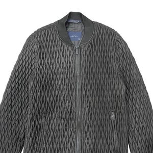 Puede incluir: Chaqueta bomber acolchada negra con un patr&oacute;n de diamantes. La chaqueta tiene una cremallera frontal, un cuello acanalado y dos bolsillos laterales. La etiqueta dice "ZARA MAN".