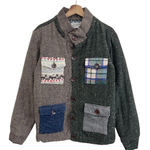May include: A patchwork jacket with a unique design. The jacket features a mix of brown and green tweed fabrics, with four pockets in various patterns and colors. It has a button-up front and a collar.