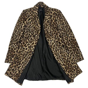 May include: A leopard print coat with a black interior lining. The coat has a classic lapel collar and a button closure. The animal print features brown and black spots on a tan background. The coat is open, displaying the black lining.