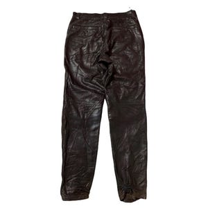 May include: Dark brown leather pants with a classic five-pocket design. The pants have a slightly worn appearance, with visible creases and texture. The leather appears to be soft and supple, suggesting a comfortable fit. The pants are suitable for casual wear.